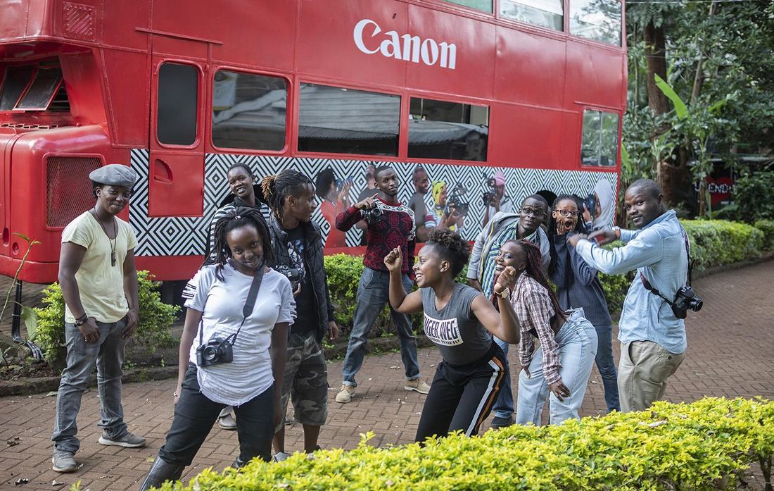 Workshop participants in front of the Canon-branded Nrb Bus