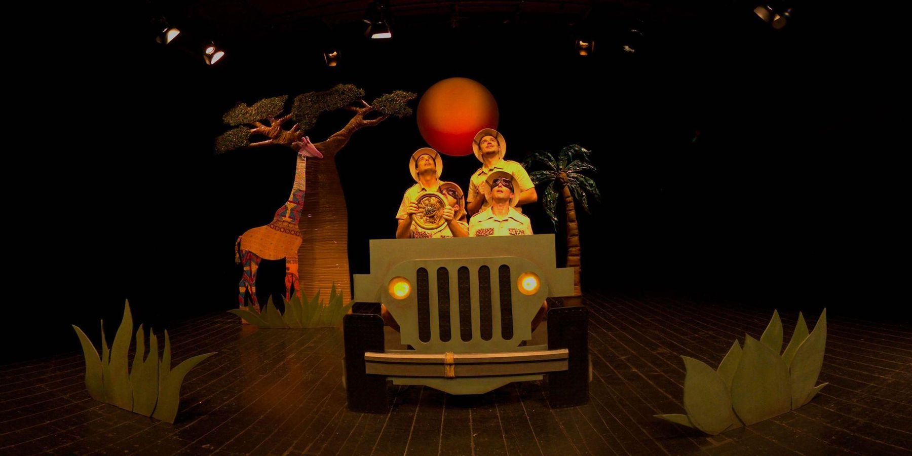 Three explorers in a cardboard jeep under a red sun, from Re-Launching Luigi Broglio