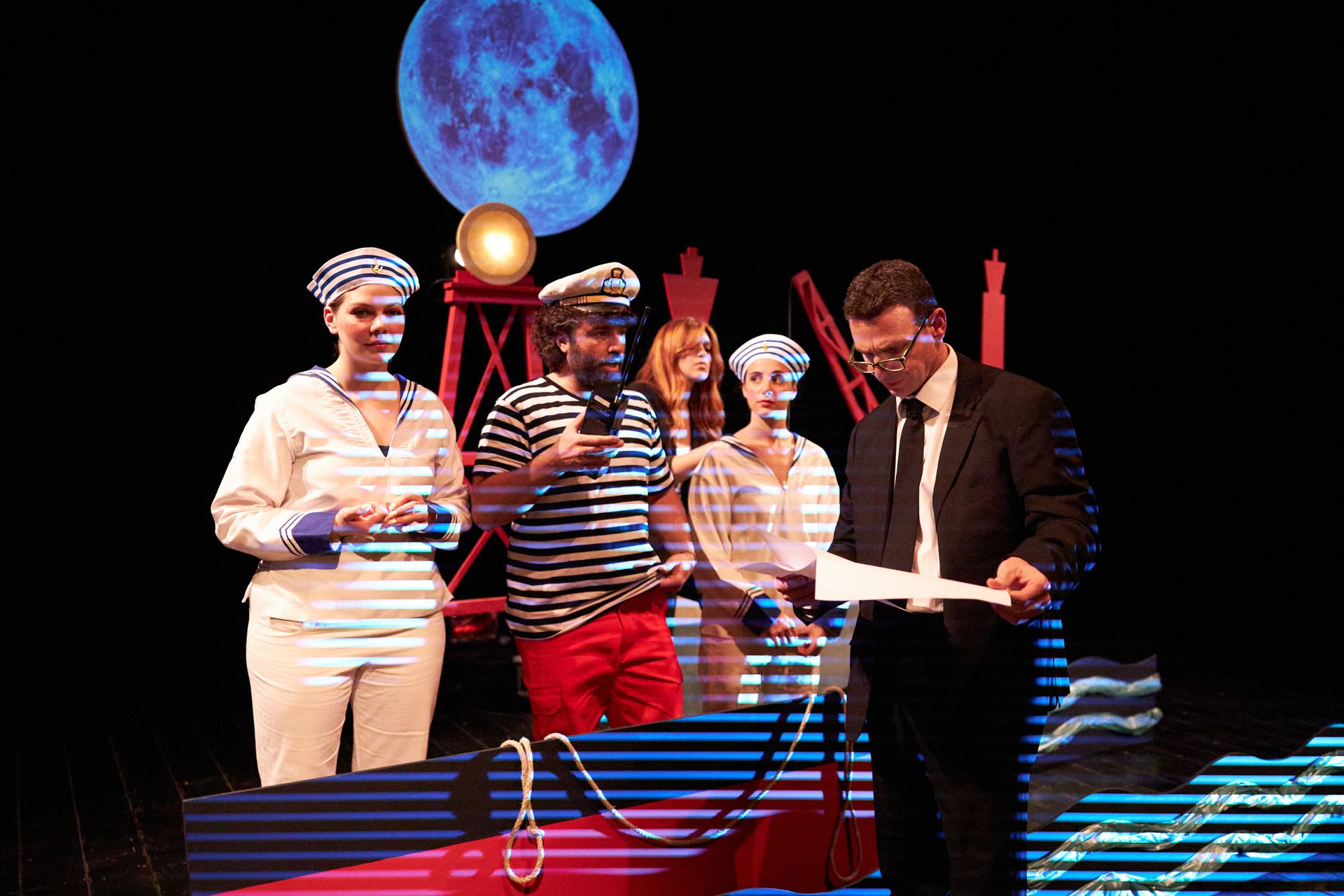 Actors dressed as sailors under a blue moon, from Re-Launching Luigi Broglio